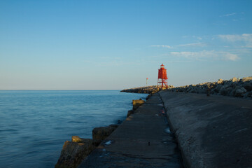 A Red Breakwater Lighthouse Along Lake Michigan