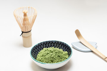 powdered matcha tea with the utensils to prepare it
