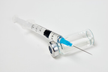 Medical vaccination concept with syringe and medical ampoules