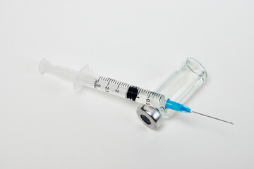 Medical vaccination concept with syringe and medical ampoules