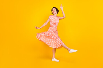 Full length body size view of lovely dreamy cheerful girl dancing having fun good mood isolated over bright yellow color background