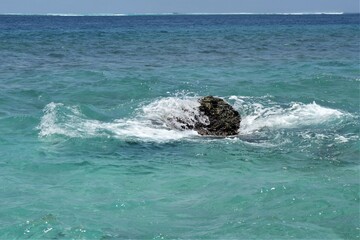 A rock surrounded by water in the indian ocean