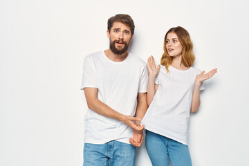 cheerful young couple in white t-shirts studio communication
