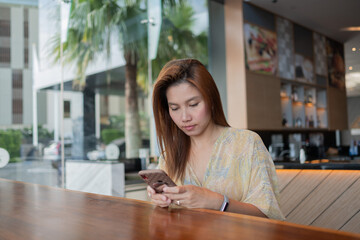 Asian girl using smartphone, woman watching mobile
