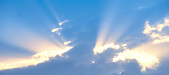 The background of sun rays over clouds. The sun rays break over the clouds.