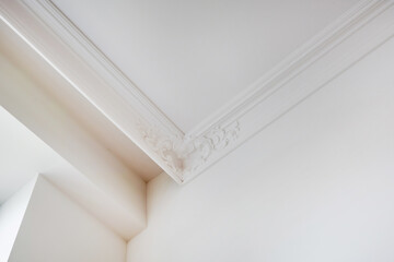 corner of ceiling and walls with intricate crown moulding. Interior construction and renovation...