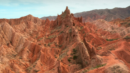 A unique aerial landscape of flying over the red stone valley. A flight along the wall of red...