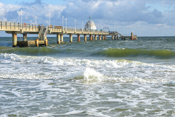 Waves at the Zinnowitz seabridge in the tourist resort at the Baltic Sea in Germany, windy weather...