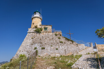 Fototapeta na wymiar Walls and lighthouse of Old Venetian Fortress in Corfu, capital of Corfu Island in Greece