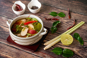 Vegetarian food, spicy soup with mushroom, chili and herb for lunch on wooden table