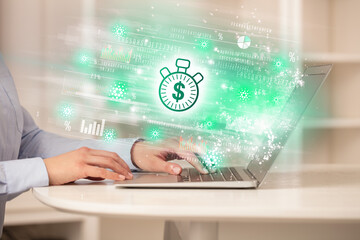 Young man watching stock market on laptop