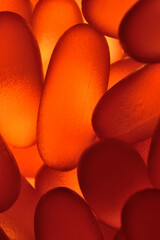 fish oil capsules illuminated from below. close-up.