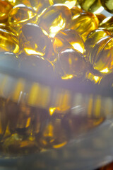 fish oil capsules illuminated from below. close-up.