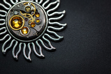 Nice handmade decoration pendant made of metal and watch parts with precious stones of different colors