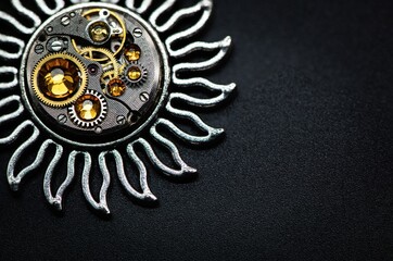 Nice handmade decoration pendant made of metal and watch parts with precious stones of different colors