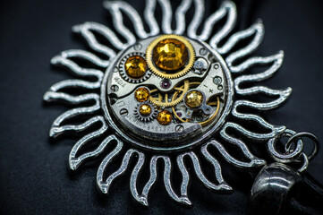 Nice handmade decoration pendant made of metal and watch parts with precious stones of different colors