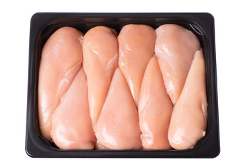 Raw chicken fillet in a packing tray. Lots of fresh skinless chicken fillets in a plastic tray in a supermarket. Raw chicken fillet. - obrazy, fototapety, plakaty