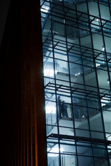 Silhouettes of security guards seen through office building windows at night
