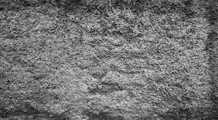 Cement wall with roughcast. Unpainted gray wall.