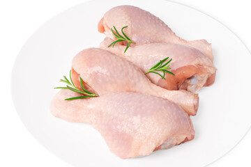 Fresh chicken legs close-up isolade.Top view of a four-piece raw whole chicken leg on a white plate on a white isolated background.