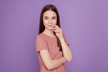 Portrait of charming lovely girl with long brown hair touch hands cheeks isolated on purple background