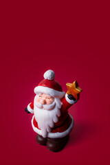 Christmas ornament of Santa Claus on red background with copy space.
