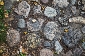 Textured beautiful natural abstract surface for wallpapers and backgrounds. Paving stones with round stones and earth between them