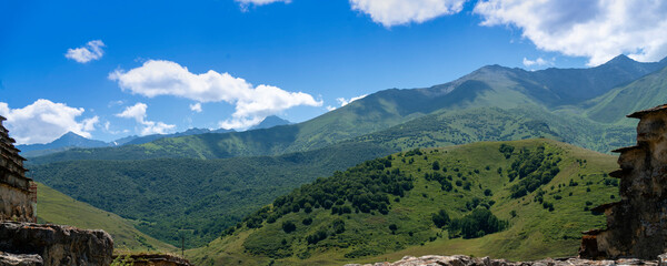 Fototapeta na wymiar Mountains of North Ossetia, beautiful summer landscapes with blue sky and clouds.