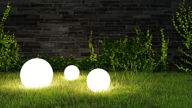 Drei Leuchtkugeln leuchten abends im Garten im Gras