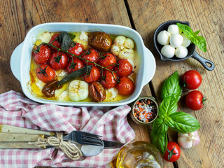 Baked vegetable tomato, basil, mozzarella cheese, garlic in the oven in ceramic dishes. cooking, cooked dish
