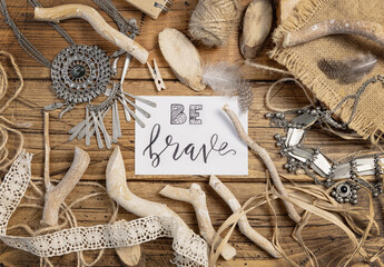 Card with the text BE BRAVE with bohemian decorations around