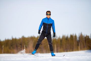 Close-up athlete is racing on winter cross country skiing