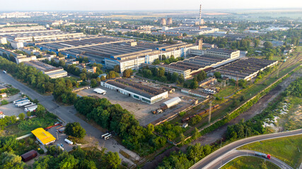 Aerial drone view flight over industrial zone on summer morning.