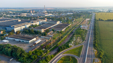 Obraz premium Aerial drone view flight over industrial zone and highway with driving cars