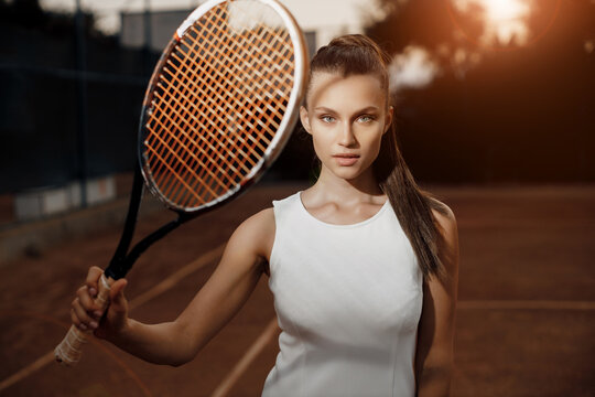 Young woman tennis player with racket. fashion portrait