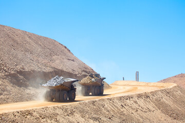 Huge dump trucks loaded with mineral  in a copper mine in Chile. © Jose Luis Stephens