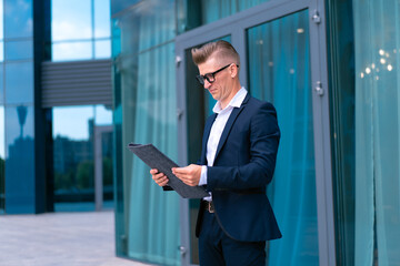 Fototapeta premium Business. Businessman Glasses Standing City Street Near Office Building .