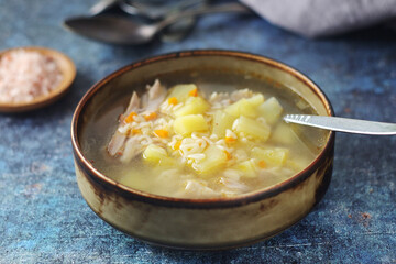 A bowl with chicken soup with pasta