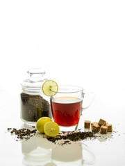 Cup of Black Tea on white background with brown sugar and lemon on side 
