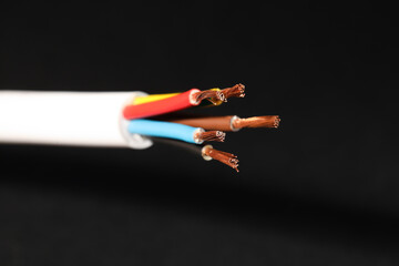 Electrical wires on black background, closeup view