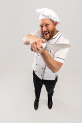 High angle view of hadsome bearded man, cook, male chef in white uniform having fun isolated on...
