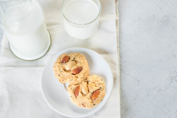 cookies and milk on white wooden background