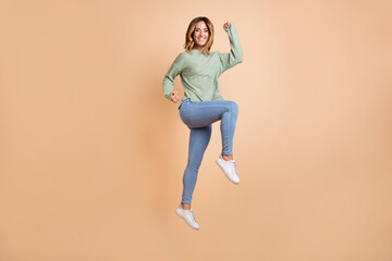 Fototapeta na wymiar Full length body size back view photo woman jumping up gesturing like winner isolated pastel beige color background