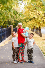 happy five-year-old grandmother and three grandchildren in autumn