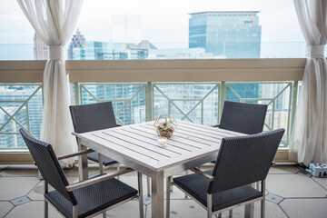 Horizon shot of a table with four chairs in balcony Captured at the Peachtree Club in Atlanta, GA - obrazy, fototapety, plakaty