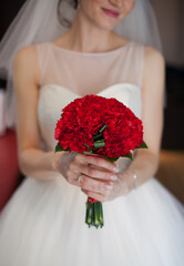 bride holding a bouquet of roses