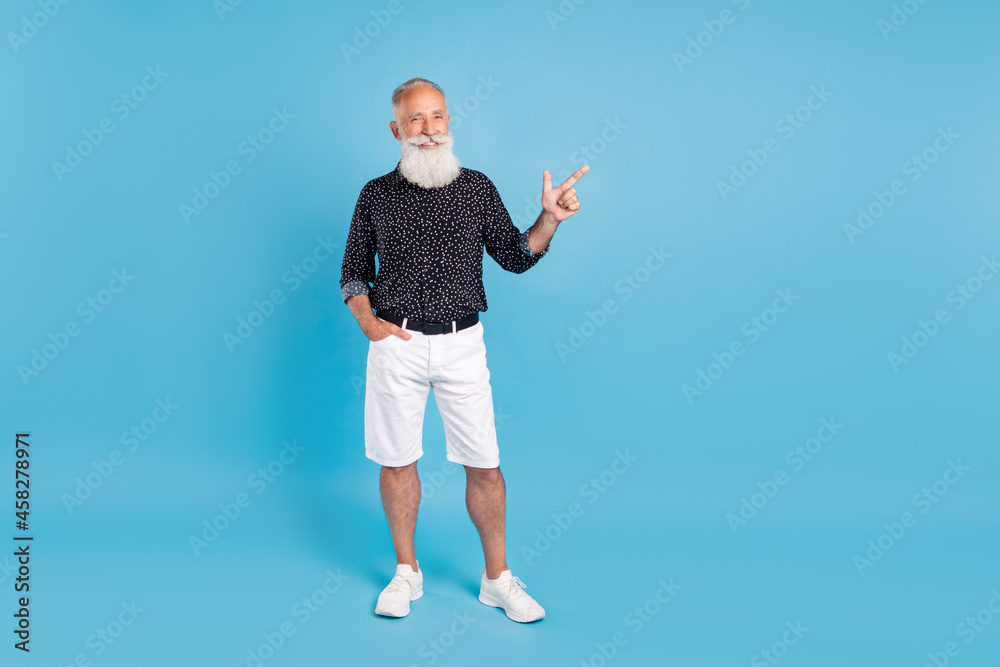 Sticker full body photo of cheerful positive man point finger empty space smile isolated on blue color backg