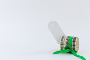 100 dollar bills tied with green gift ribbon and white blank for notes. Mock up.
