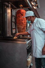 Mexican taquero working doing tacos