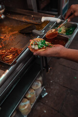 hand holding a pork taco